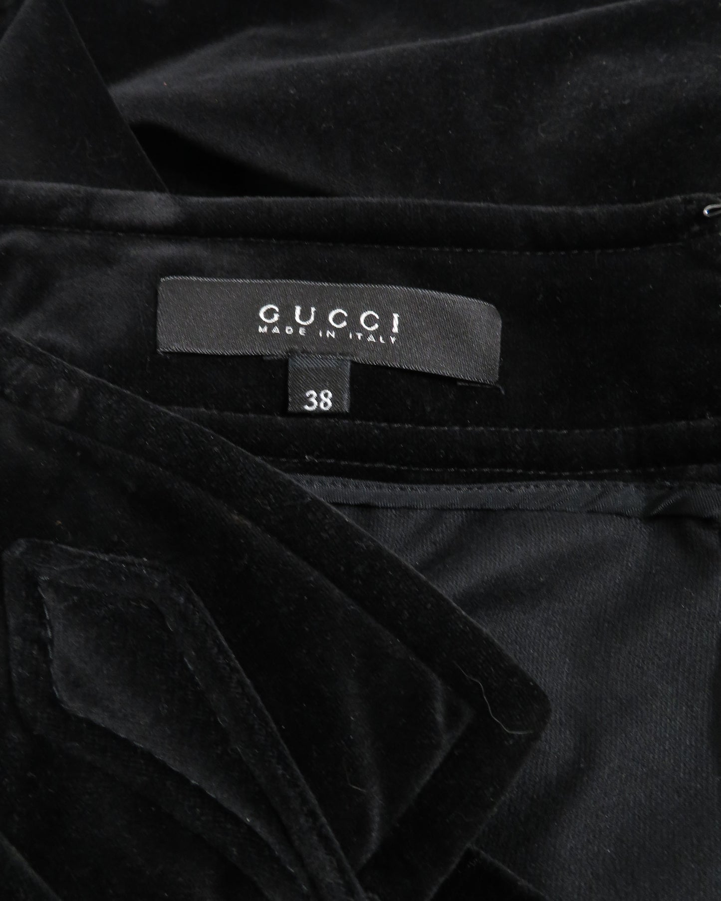 Black velvet garment with Gucci label and size 38 tag.