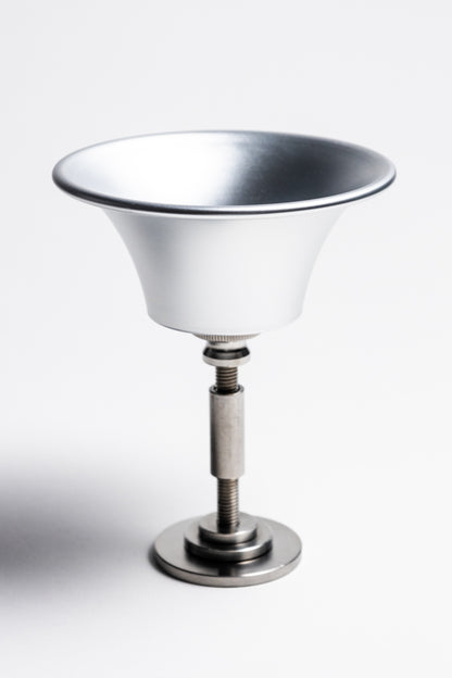 Metallic glass holder with a white bowl on a white background