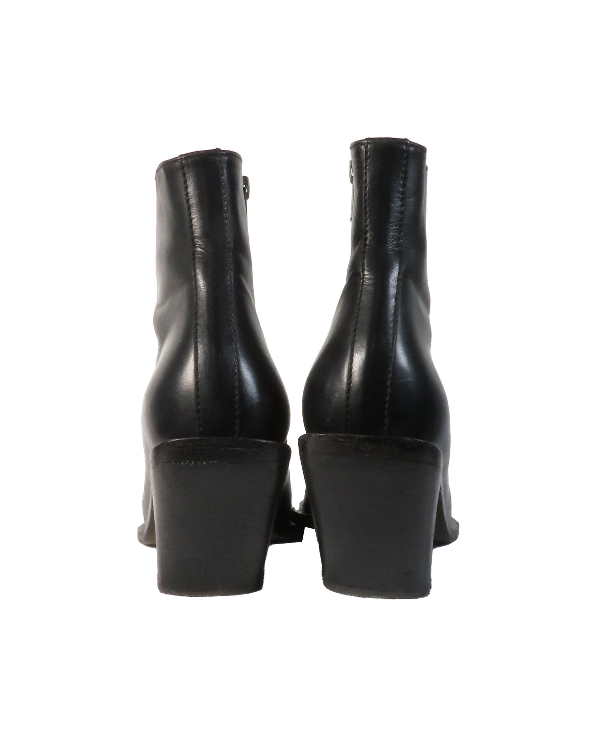 Black leather ankle boots on a white background