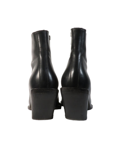 Black leather ankle boots on a white background
