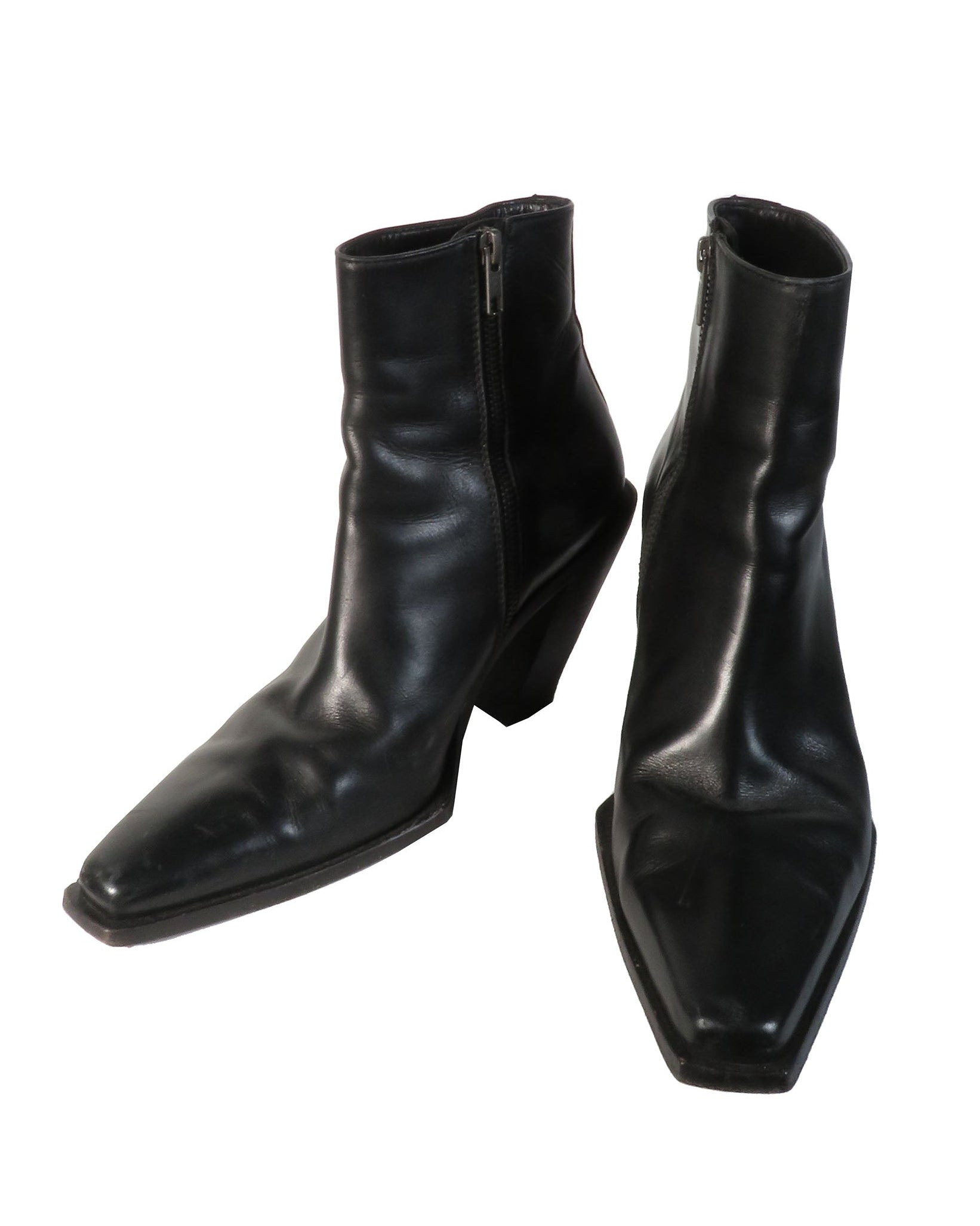 Pair of black leather ankle boots on a white background