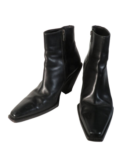 Pair of black leather ankle boots on a white background