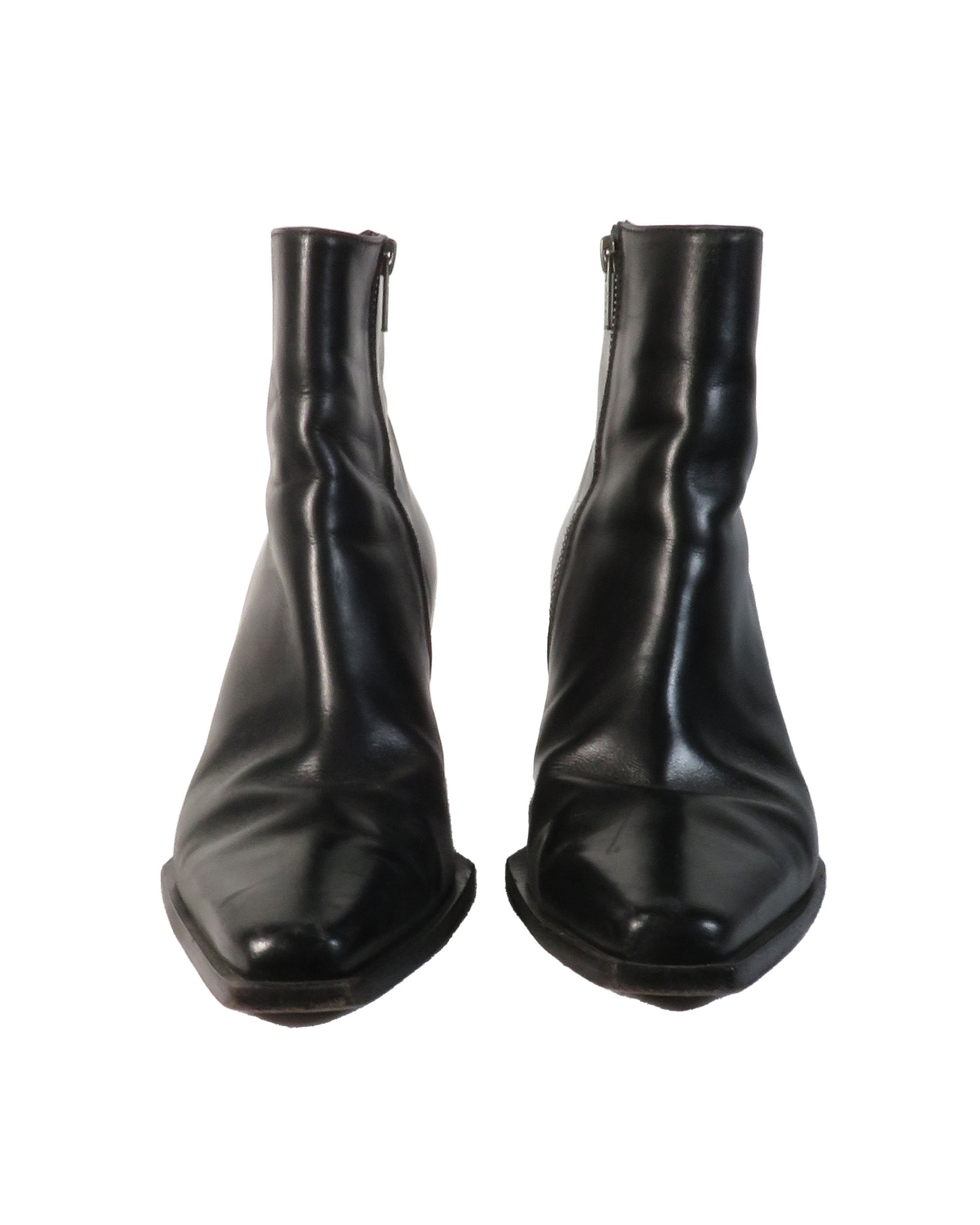 Pair of black leather ankle boots on a white background