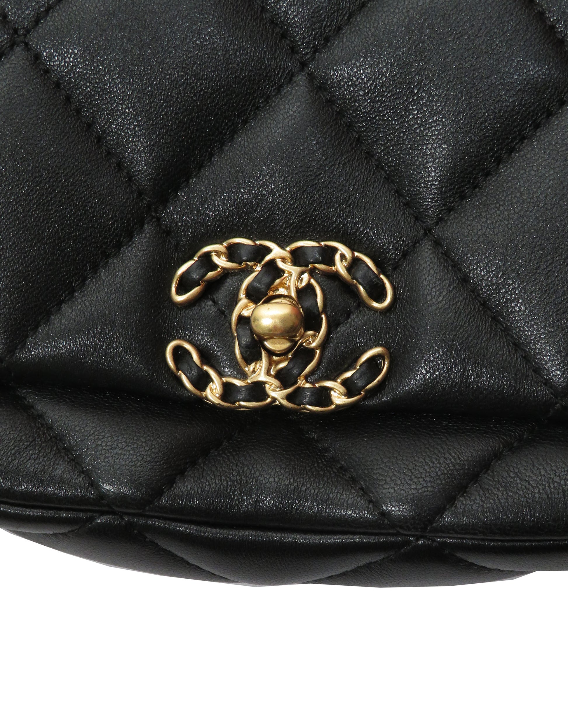 Black quilted handbag with gold chain and CC logo on a white background