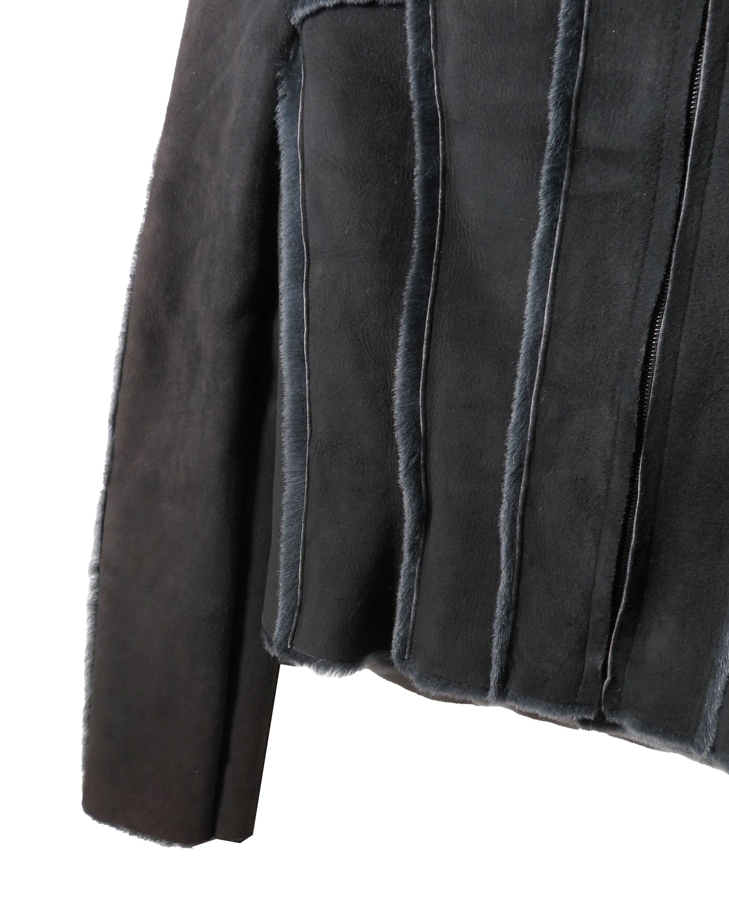 Close-up of a dark gray suede jacket with frayed edges on a white background