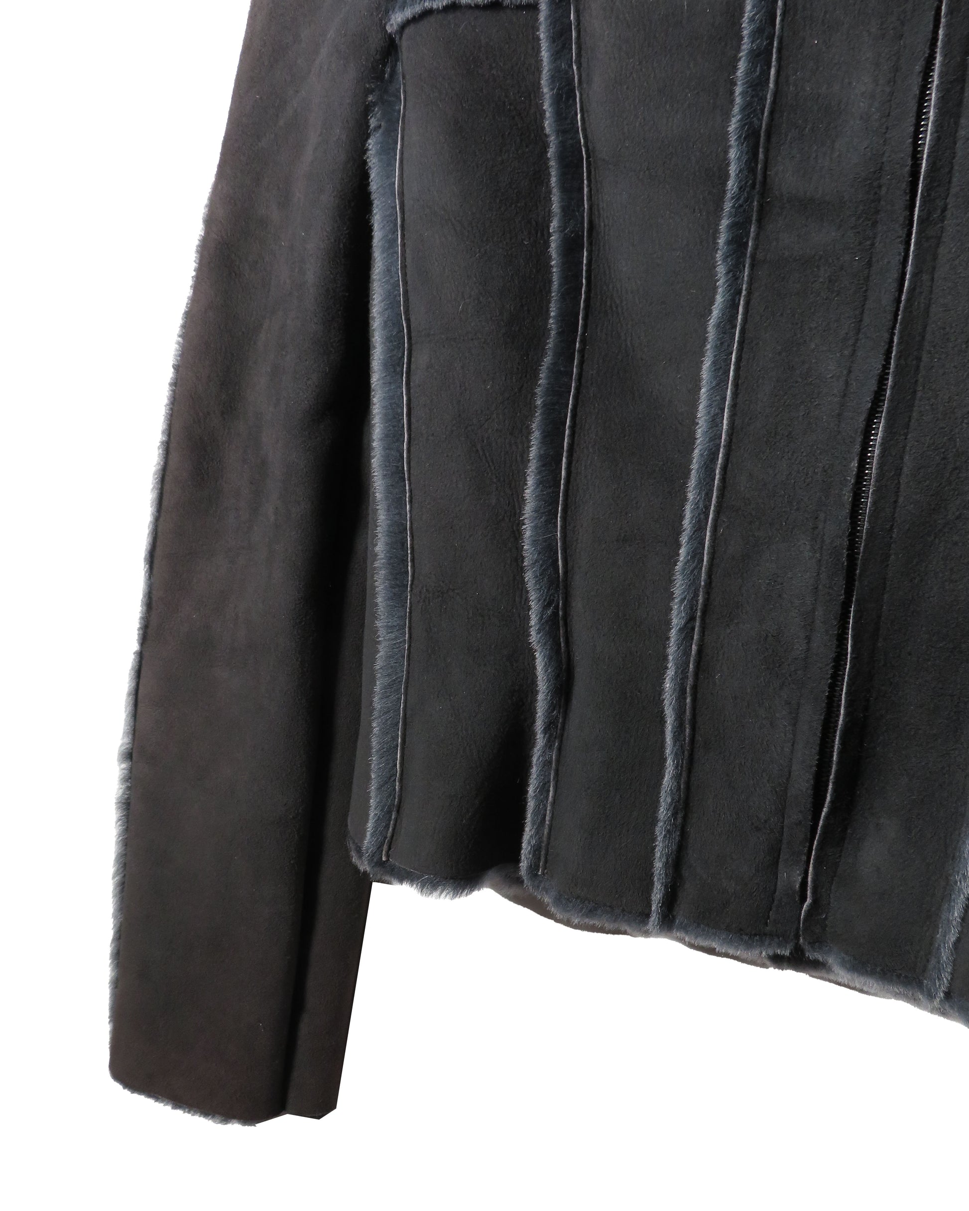Close-up of a dark gray suede jacket with frayed edges on a white background