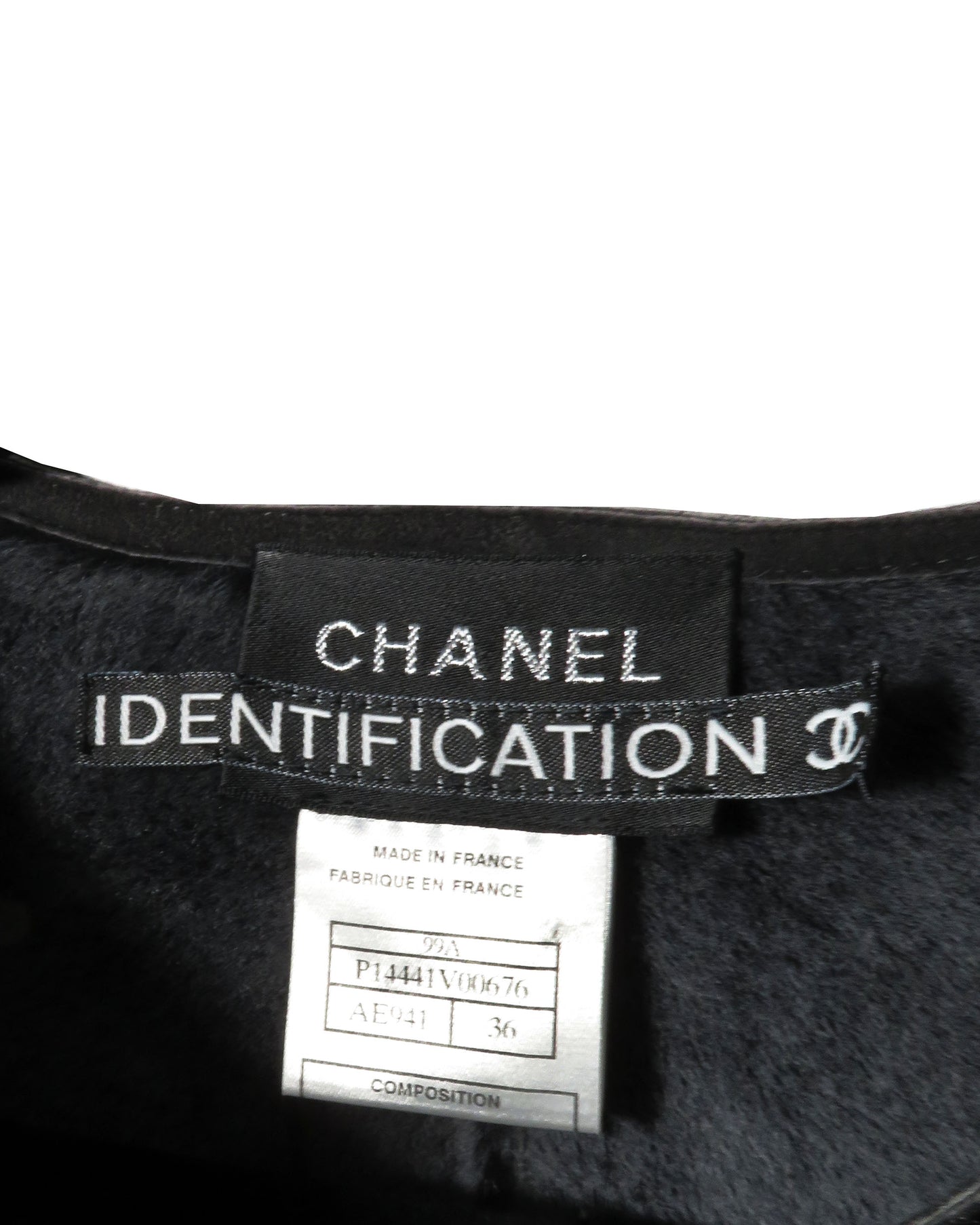 Chanel identification label on a garment with a white background