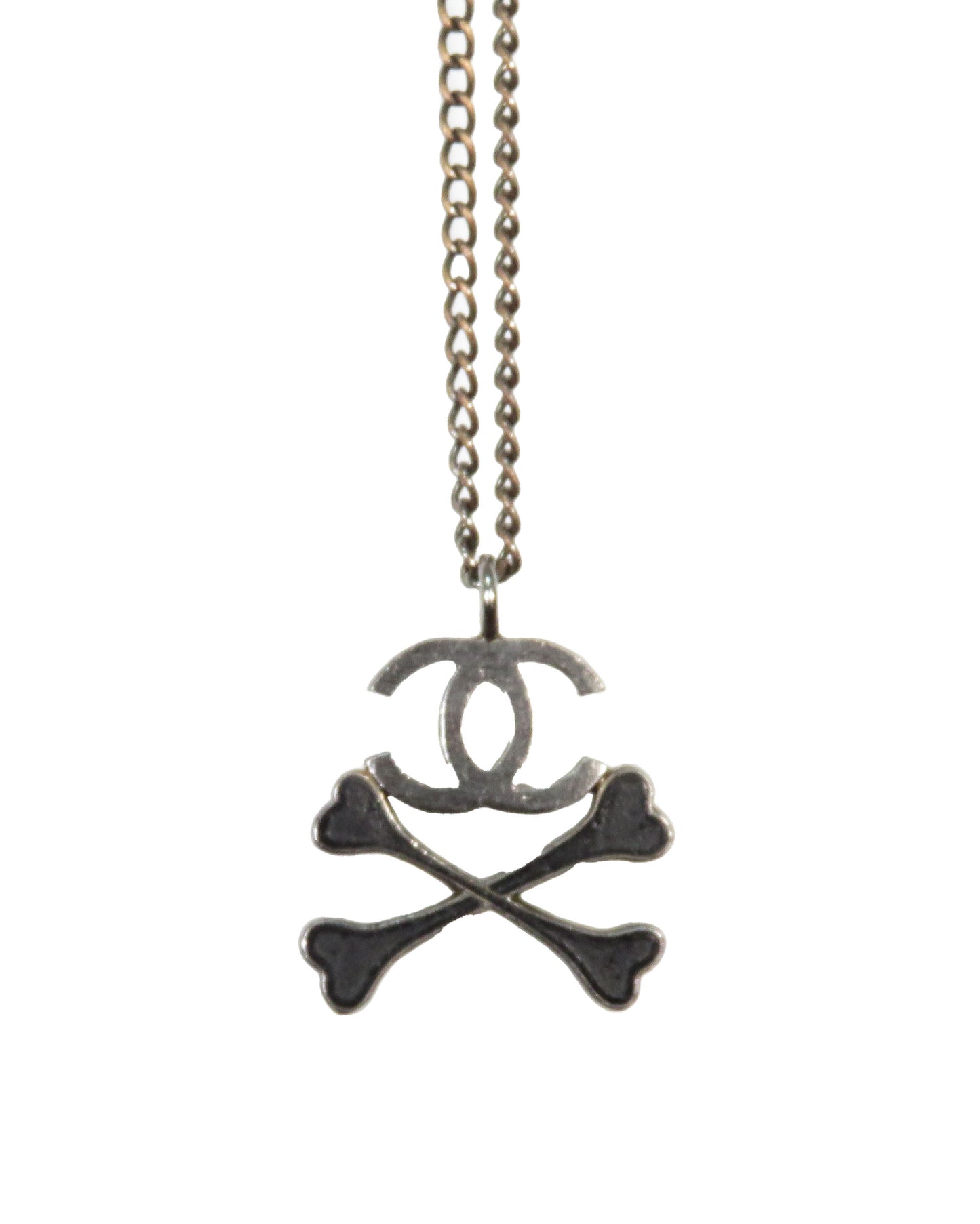 Chanel necklace with skull and crossbones design on a white background