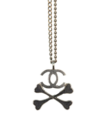 Chanel necklace with skull and crossbones design on a white background