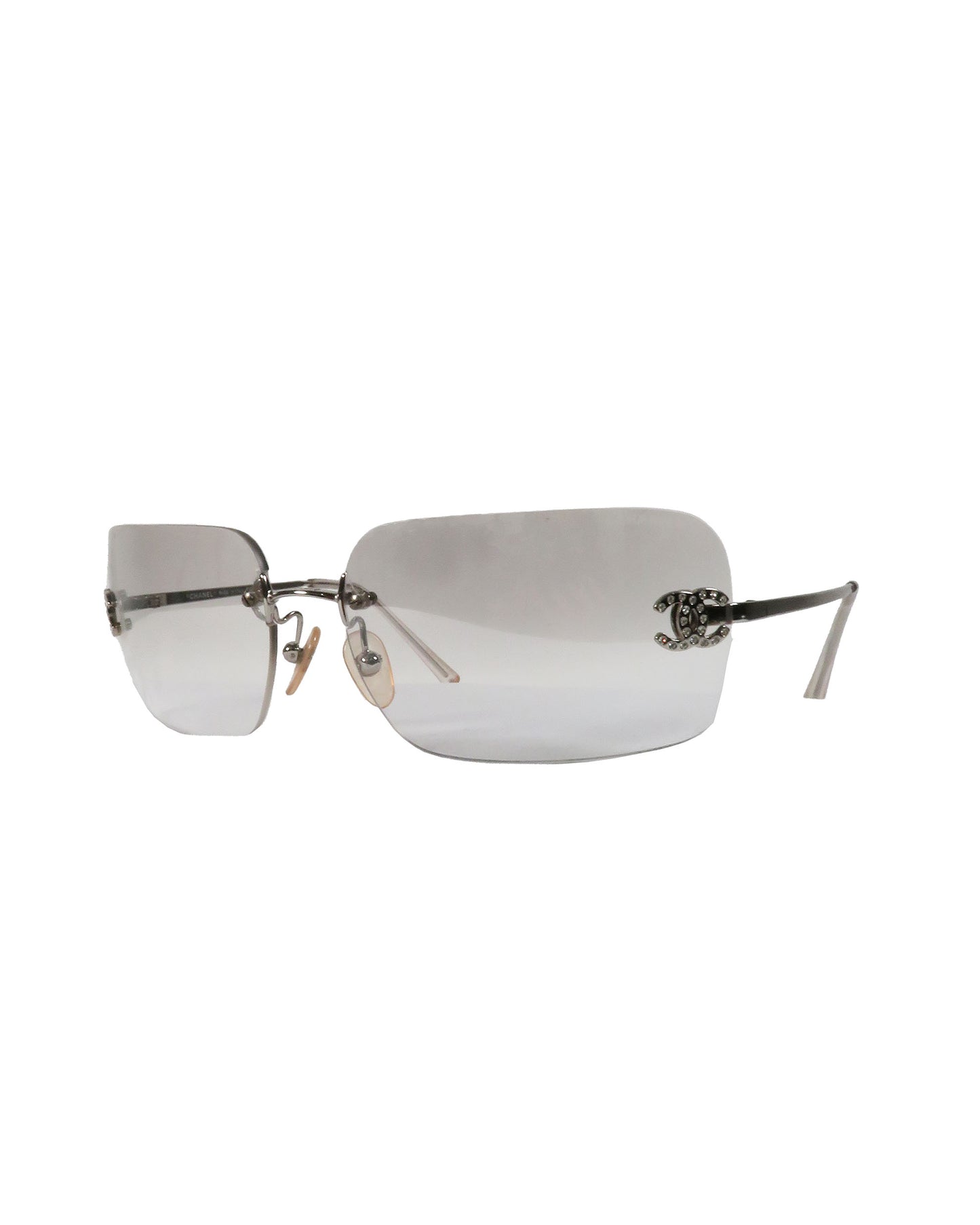 Silver rimless sunglasses on a white background
