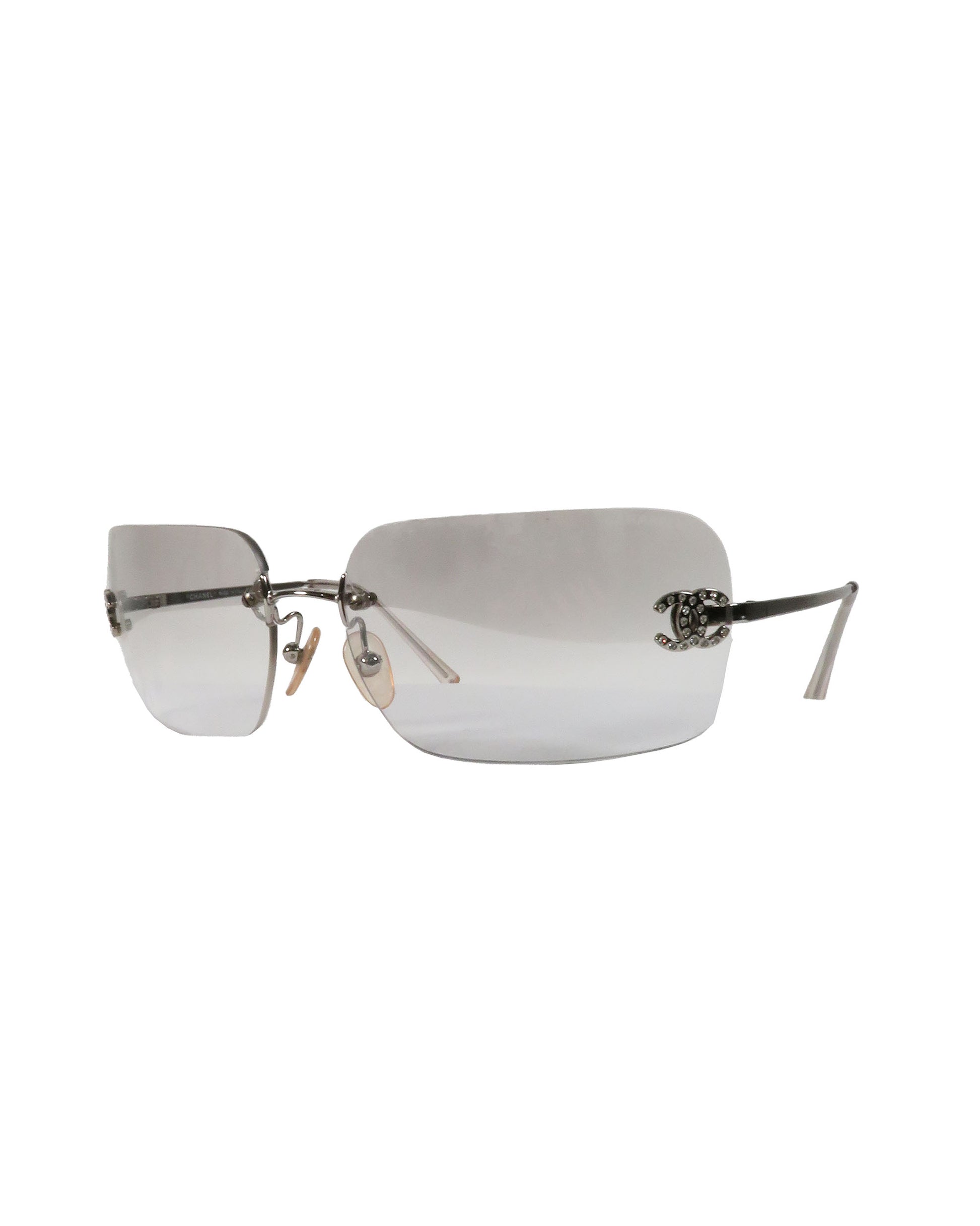 Silver rimless sunglasses on a white background