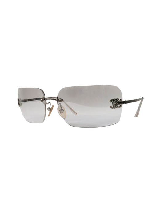 Silver rimless sunglasses on a white background