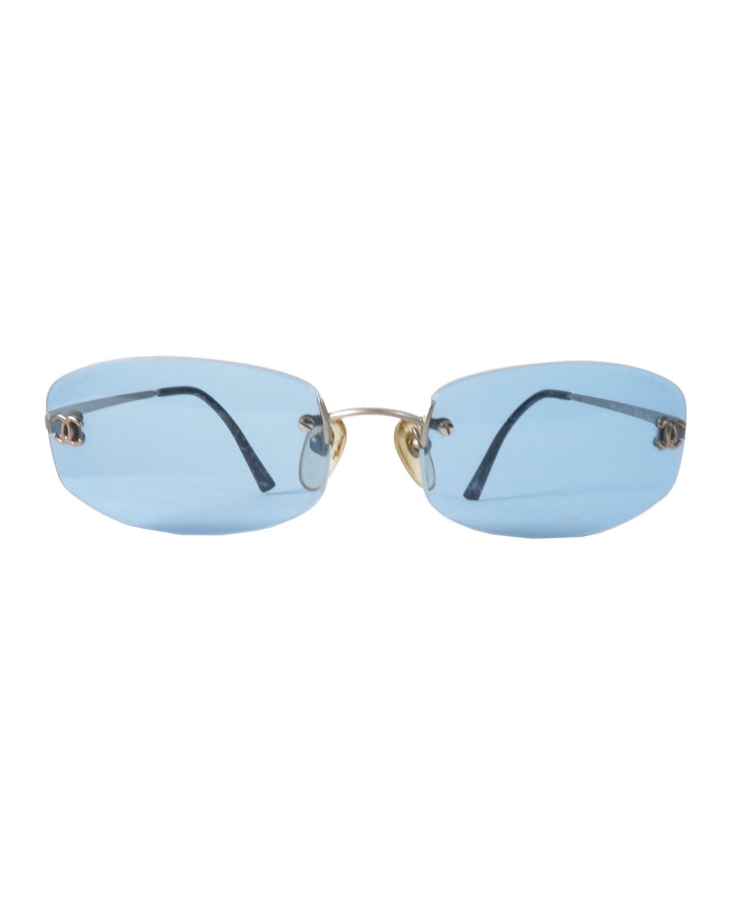Sunglasses with blue lenses and gold frames on a white background