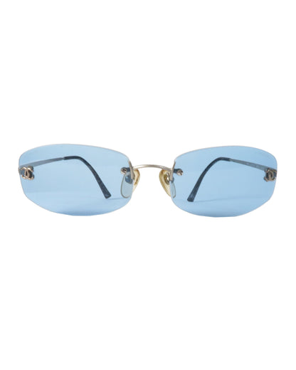 Sunglasses with blue lenses and gold frames on a white background