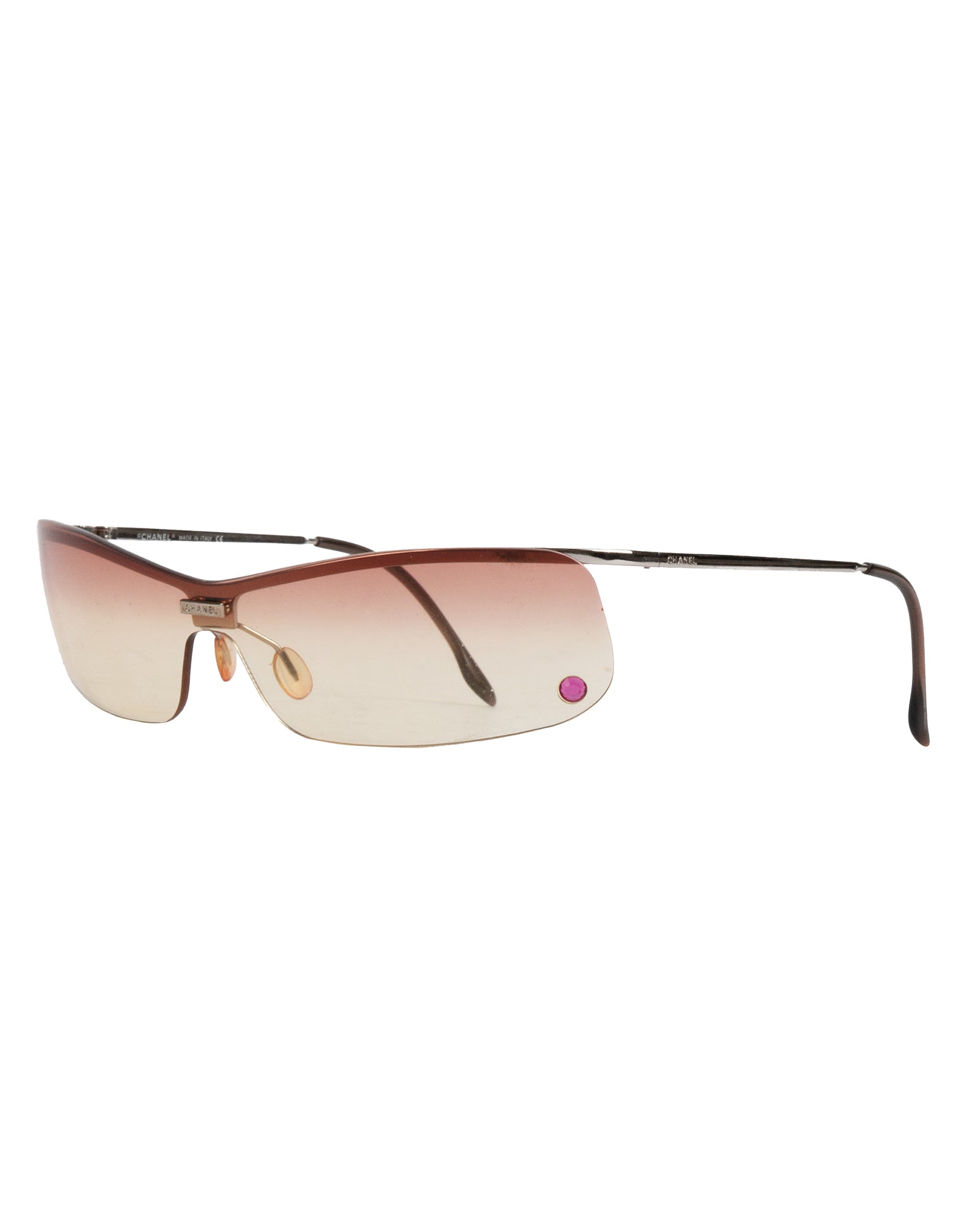 Chanel rimless gradient sunglasses with a metallic frame and pink to beige lens transition. The sunglasses feature the Chanel CC logo at the bridge with a pink rhinestone.