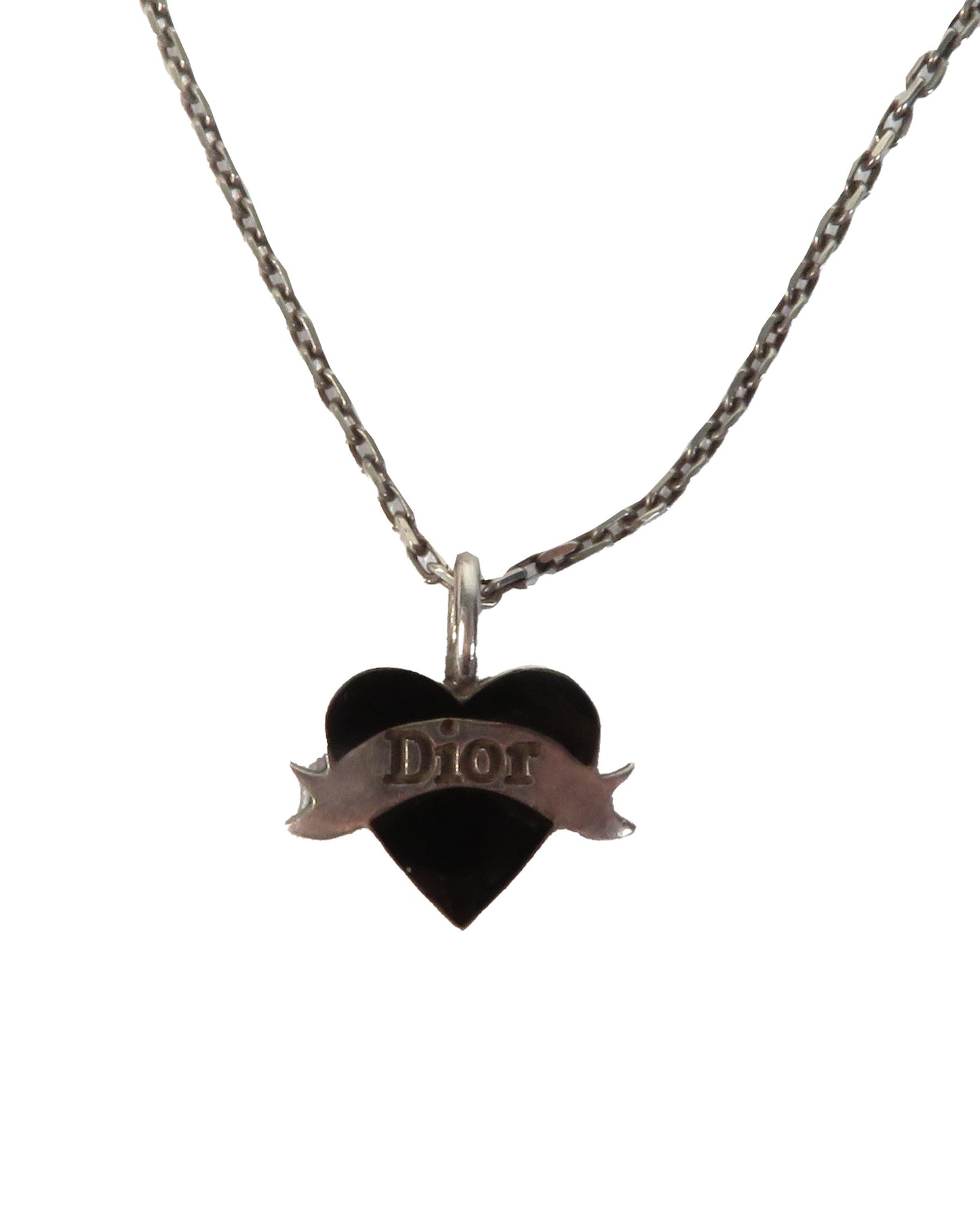 Heart-shaped Dior pendant on a chain against a white background