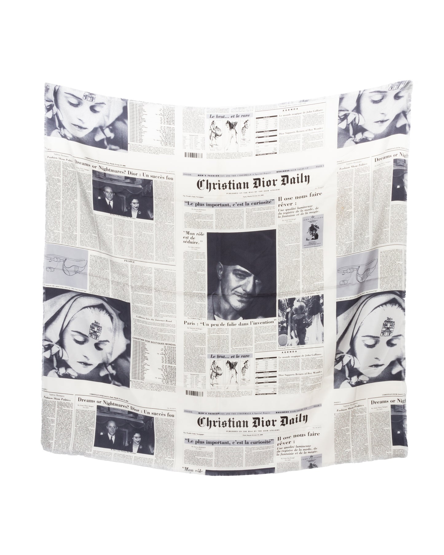 A Christian Dior silk scarf with a monochrome newspaper print design, featuring vintage-style headlines and photographs, displayed flat with fringe edges visible.