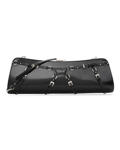 Black patent calfskin clutch with buckle and strap bondage detailing, silver-tone hardware, and a chain strap.