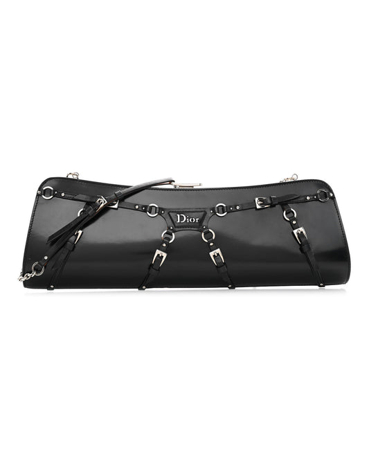 Black patent calfskin clutch with buckle and strap bondage detailing, silver-tone hardware, and a chain strap.