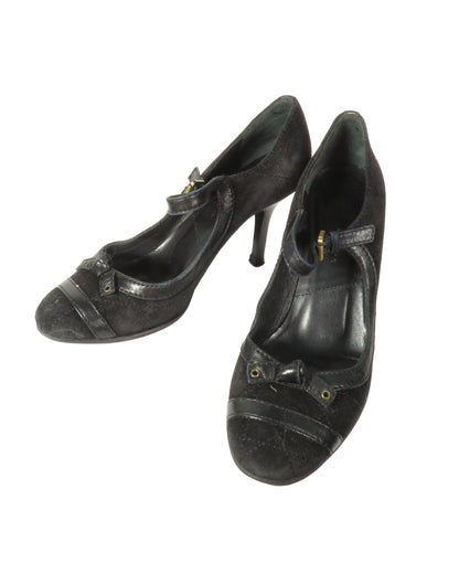 Pair of black high-heeled shoes on a white background