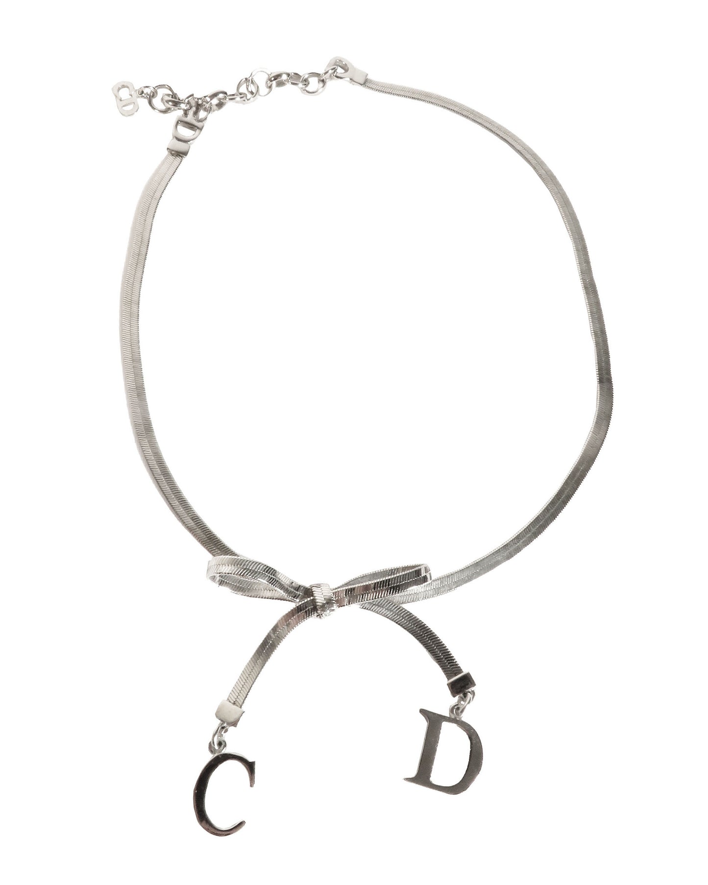 Necklace with a bow and 'CD' charms on a white background