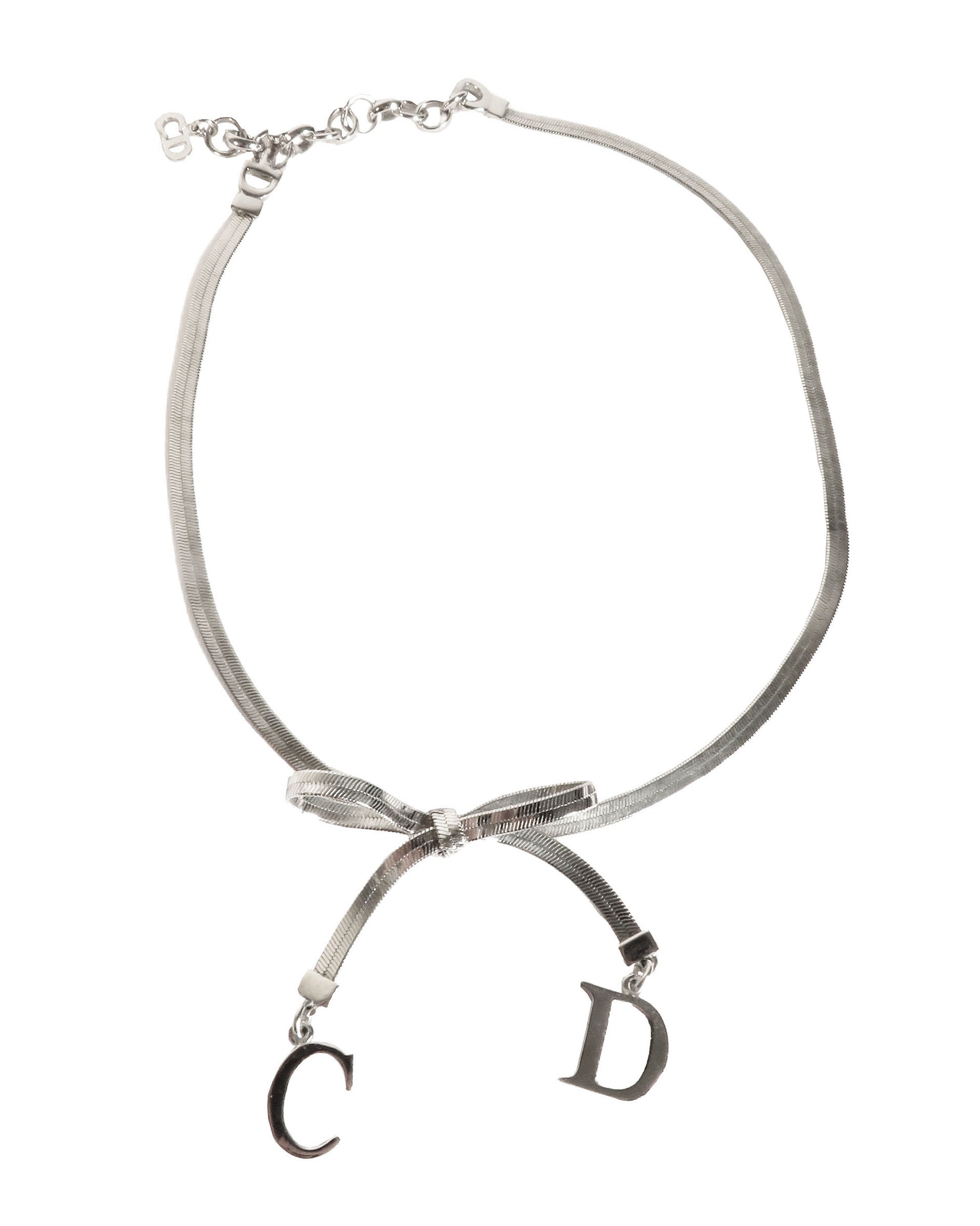 Necklace with a bow and 'CD' charms on a white background