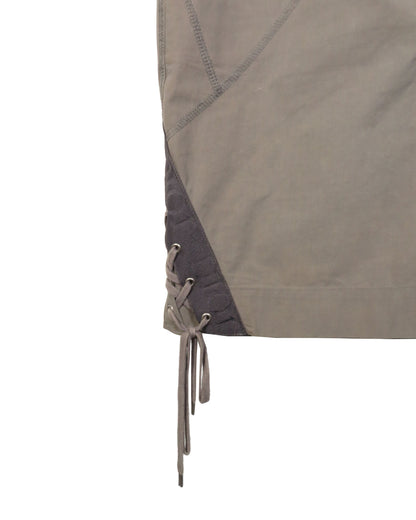 Close-up of a brown jacket with lace-up front on a white background