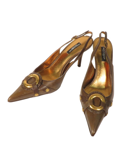 Pair of gold and brown high-heeled shoes on a white background
