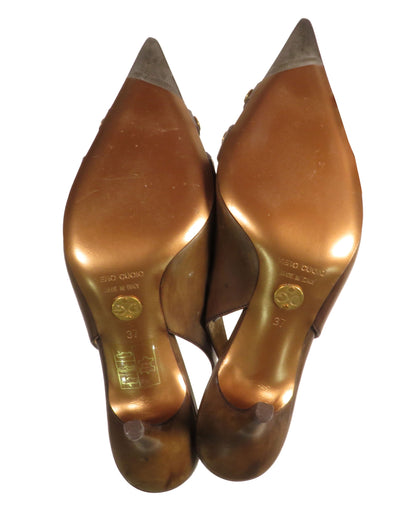 Pair of gold high-heeled shoes on a white background