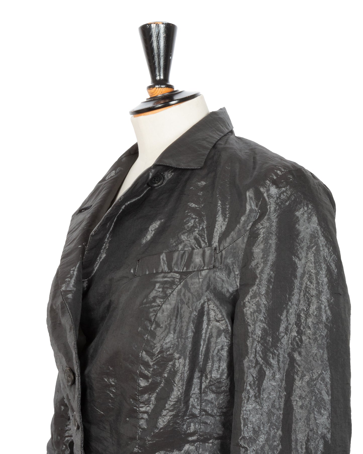 Black textured jacket on a mannequin against a white background