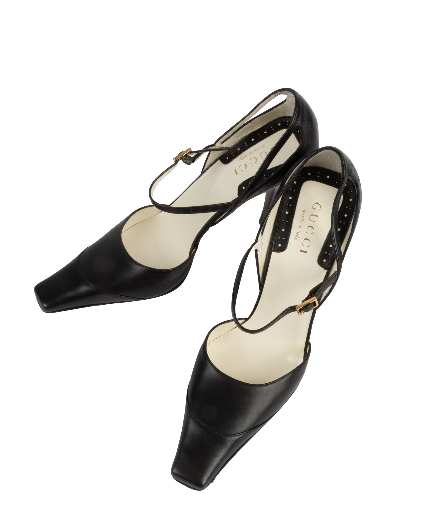 Pair of black high-heeled shoes with studded details on a white background