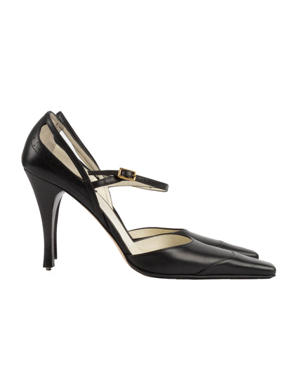 Black high-heeled shoe with a strap on a white background