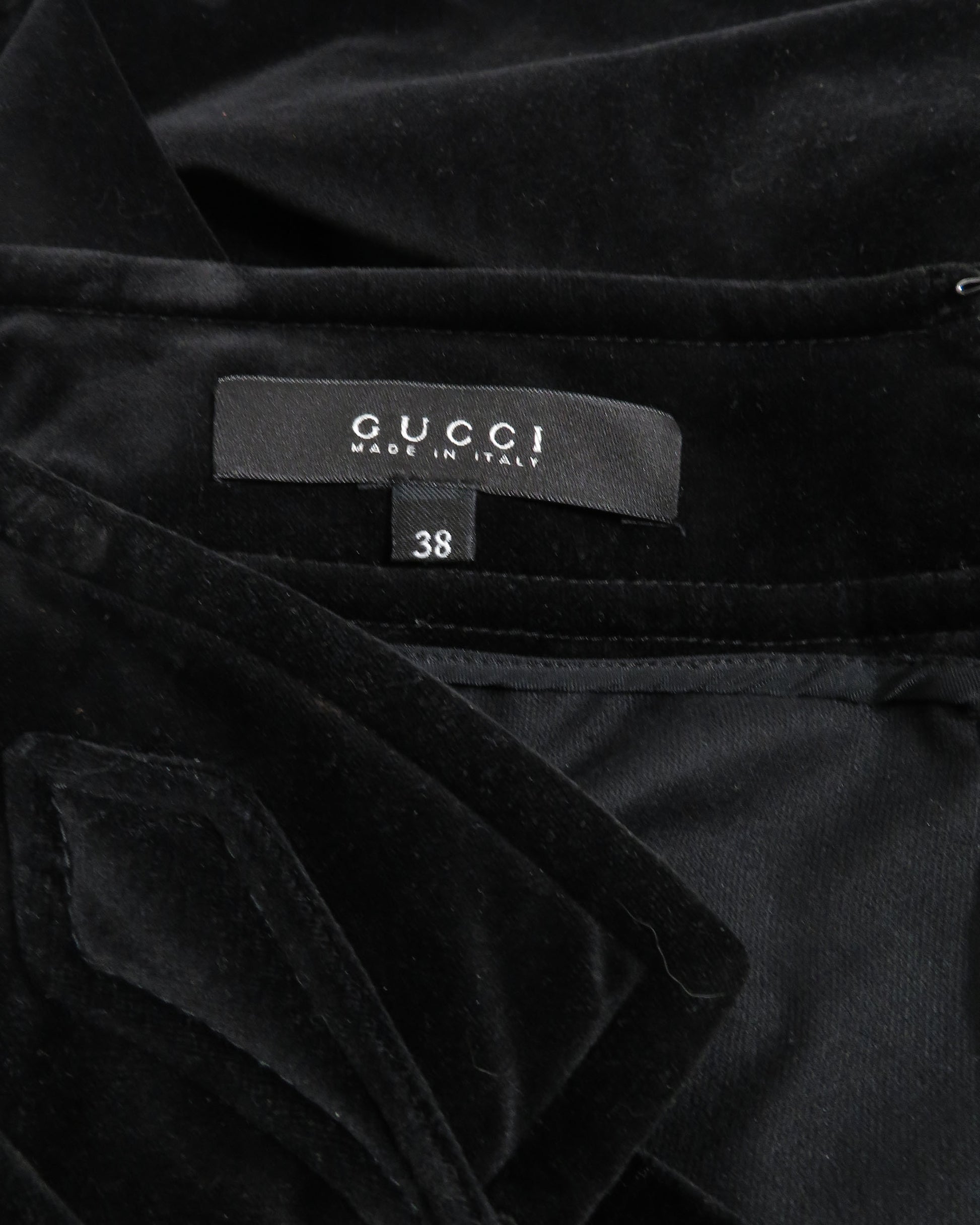 Black velvet garment with Gucci label and size 38 tag.