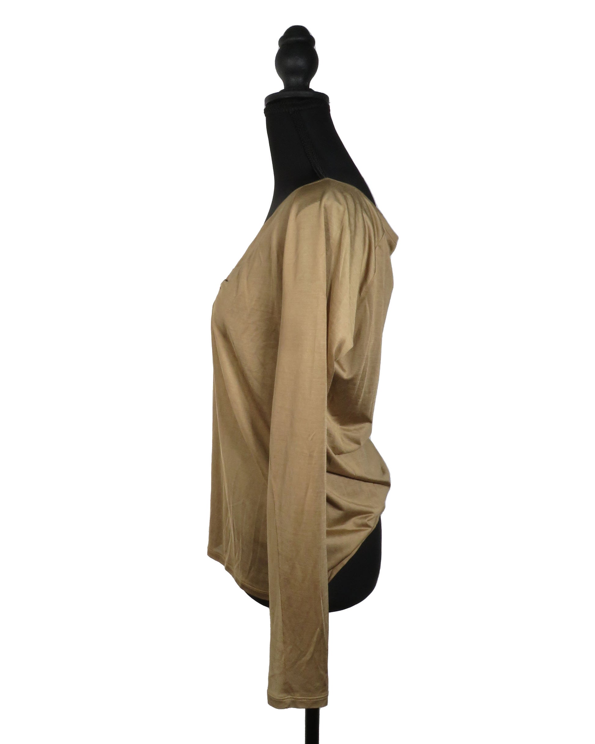 Beige long-sleeve top on a mannequin against a white background