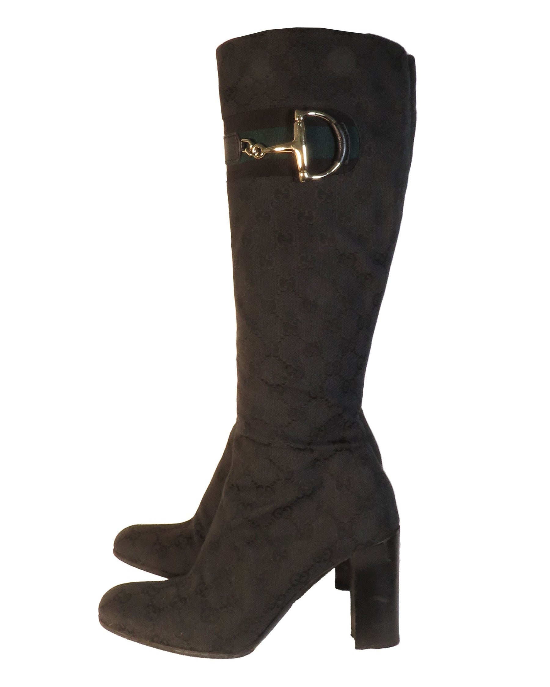 Dark brown knee-high boot with a gold buckle on a white background