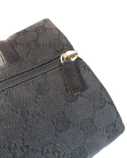 Black textured bag with gold zipper pull on a white background