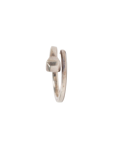 A sterling silver wrap ring with a nail shape design, featuring an engraved logo on the inner band.