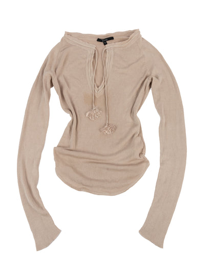 Beige silk long sleeve top with deep v-neckline and tassel tie closures, ribbed trim along the neckline, and subtle waist shaping. The top is displayed on a white background.