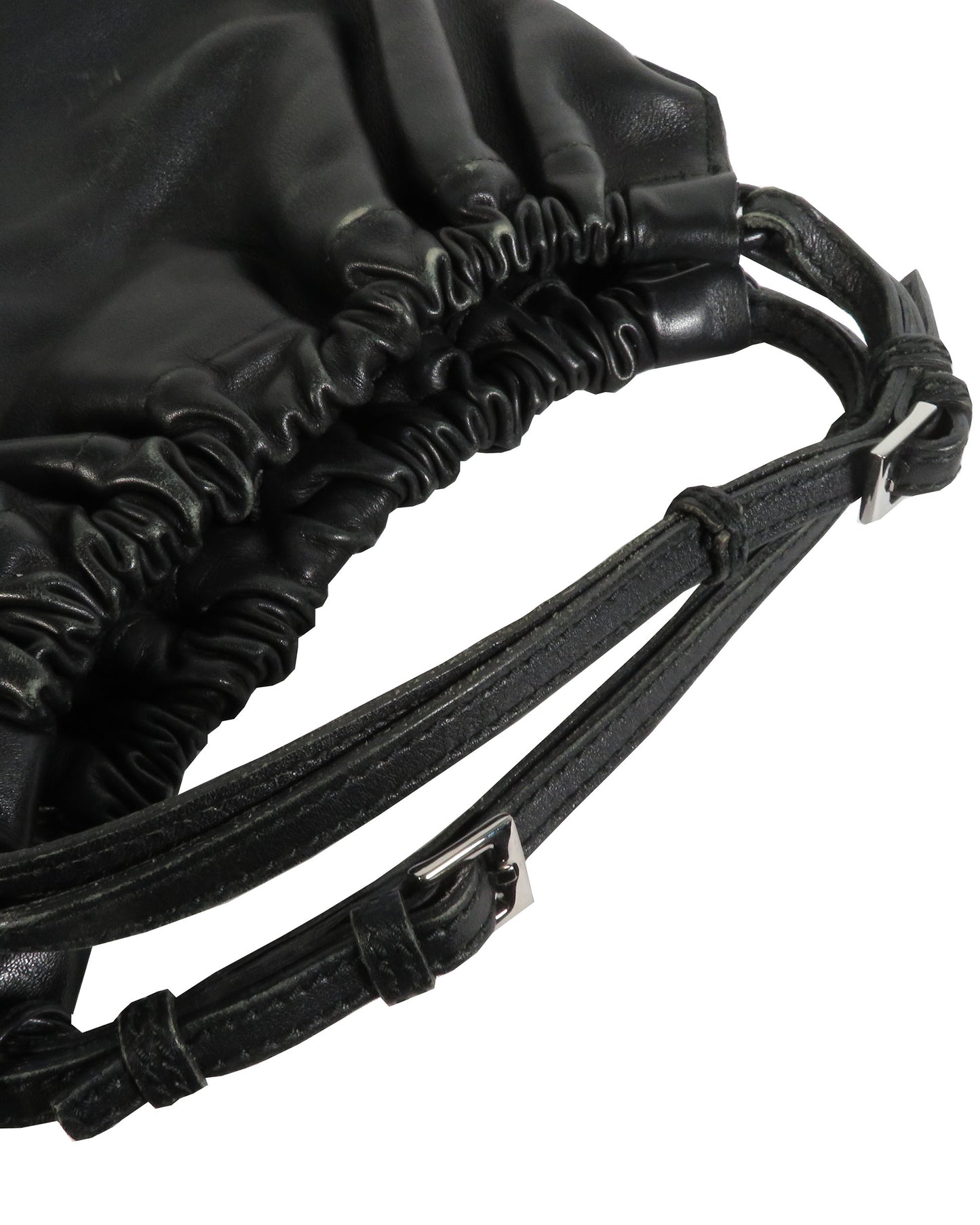 Close-up of a black drawstring bag with leather straps on a white background