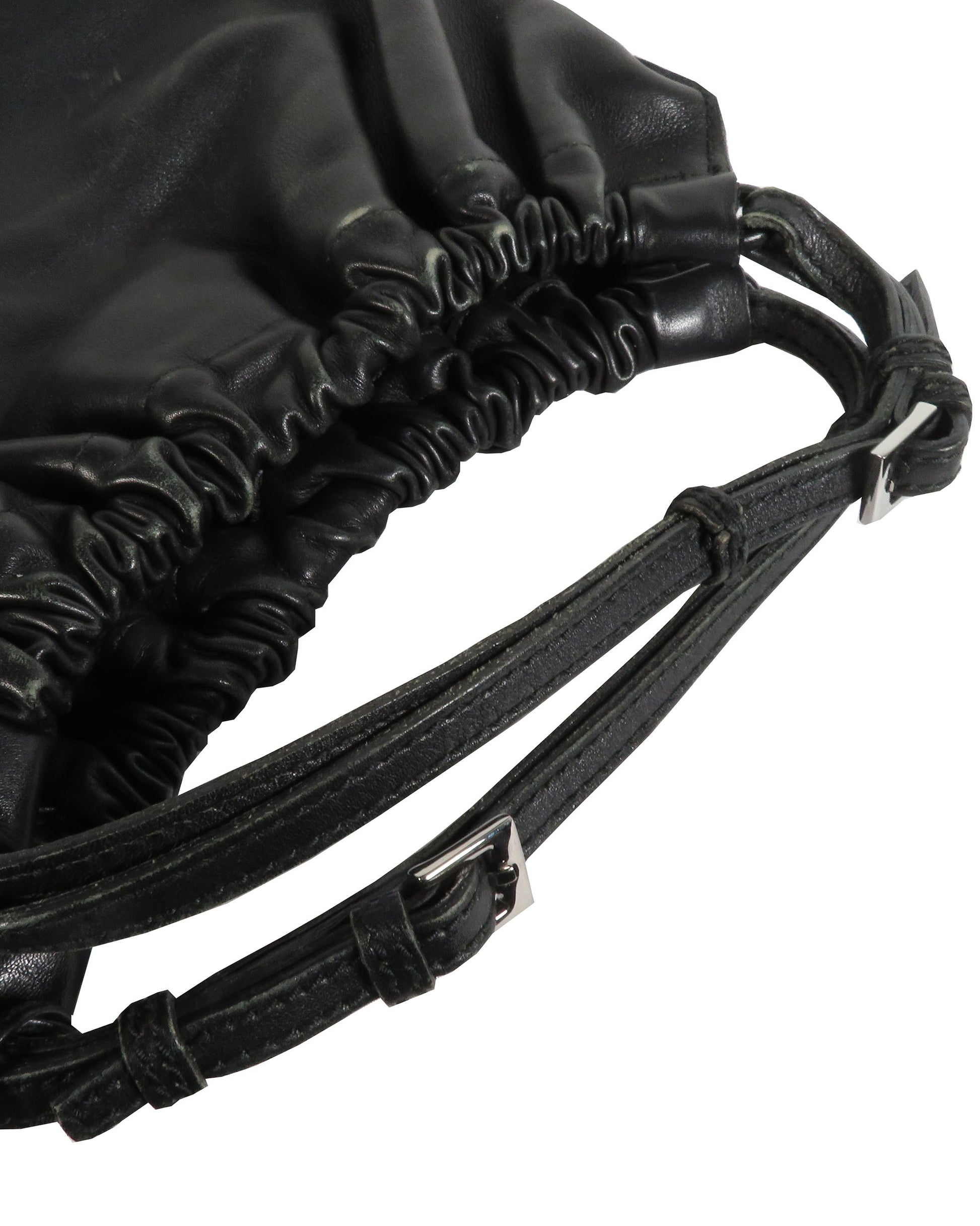 Close-up of a black drawstring bag with leather straps on a white background