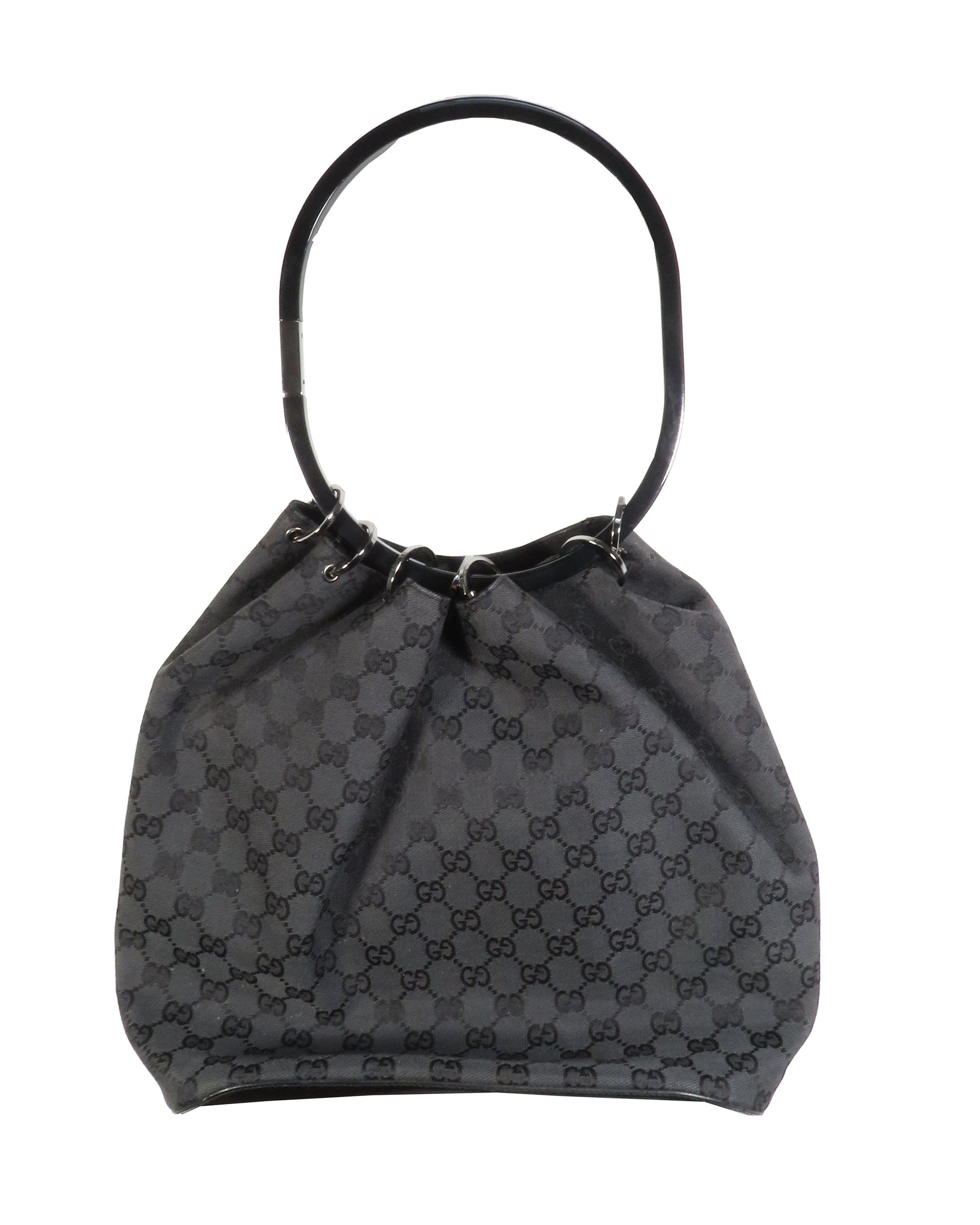 Black handbag with a pattern on a white background