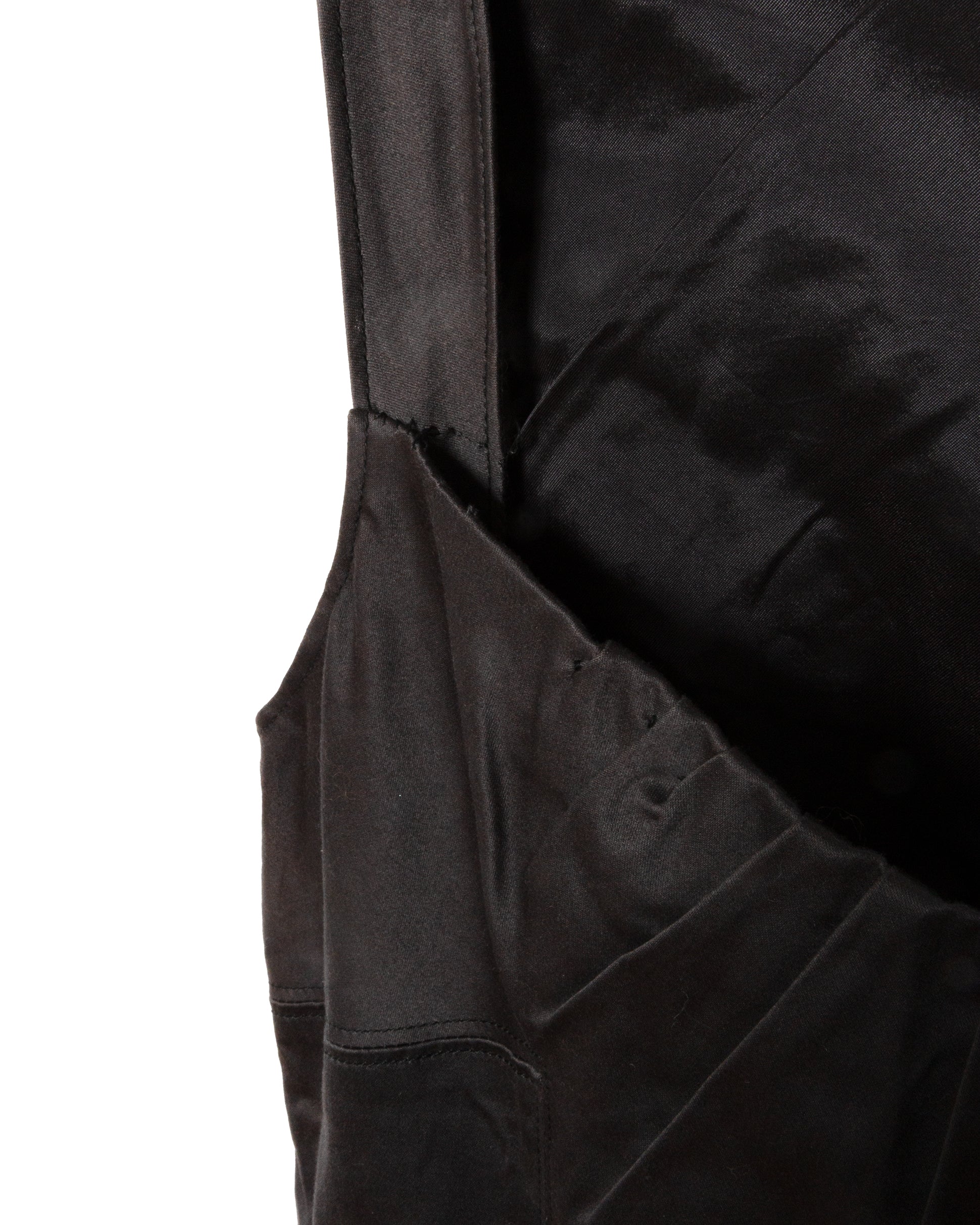 Close-up of a black garment with a pocket.