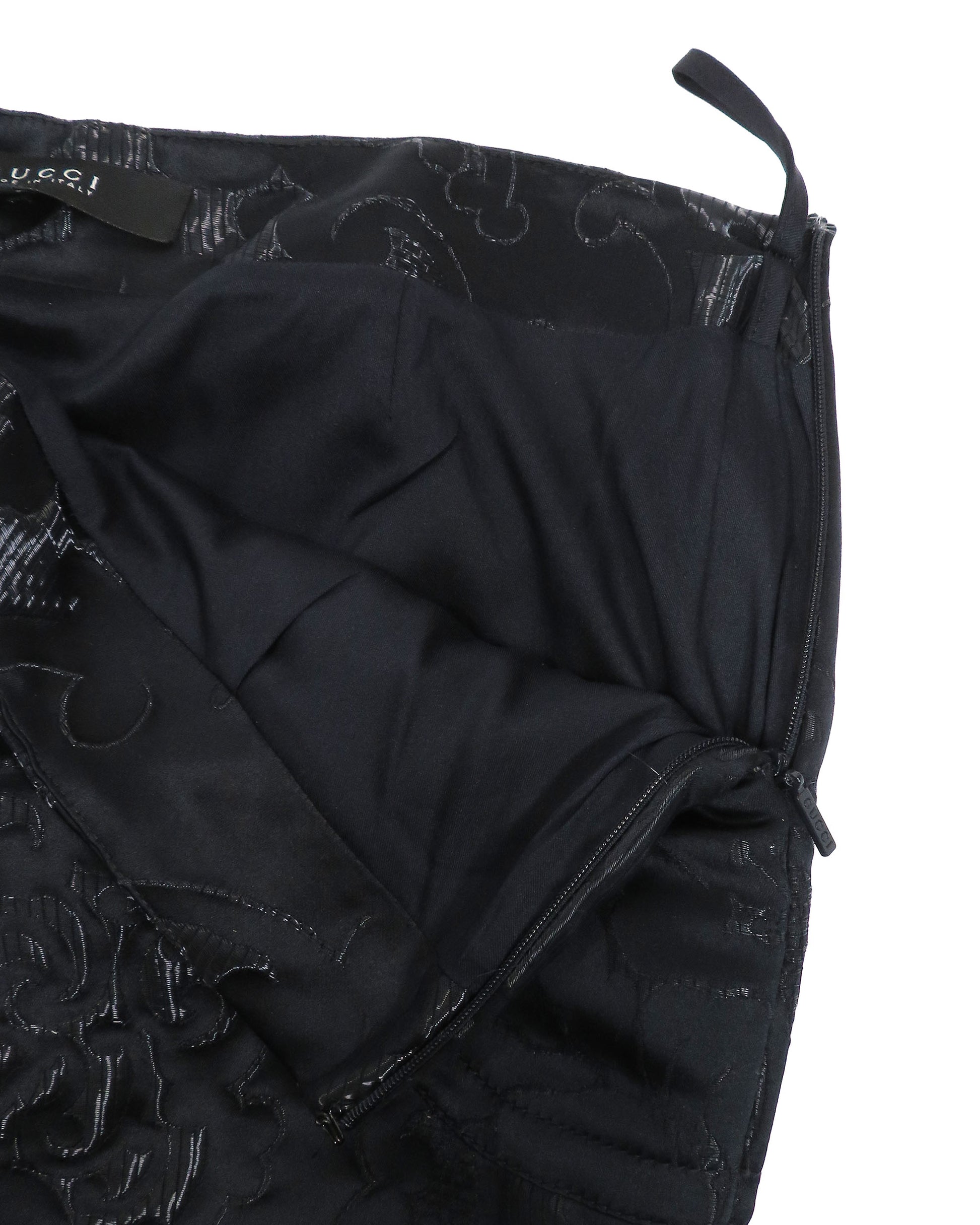 Black quilted jacket with floral pattern on a white background