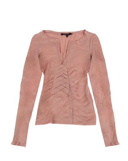 A long sleeve pink cotton top with a deep V-neckline and layered pleated detailing at the front.