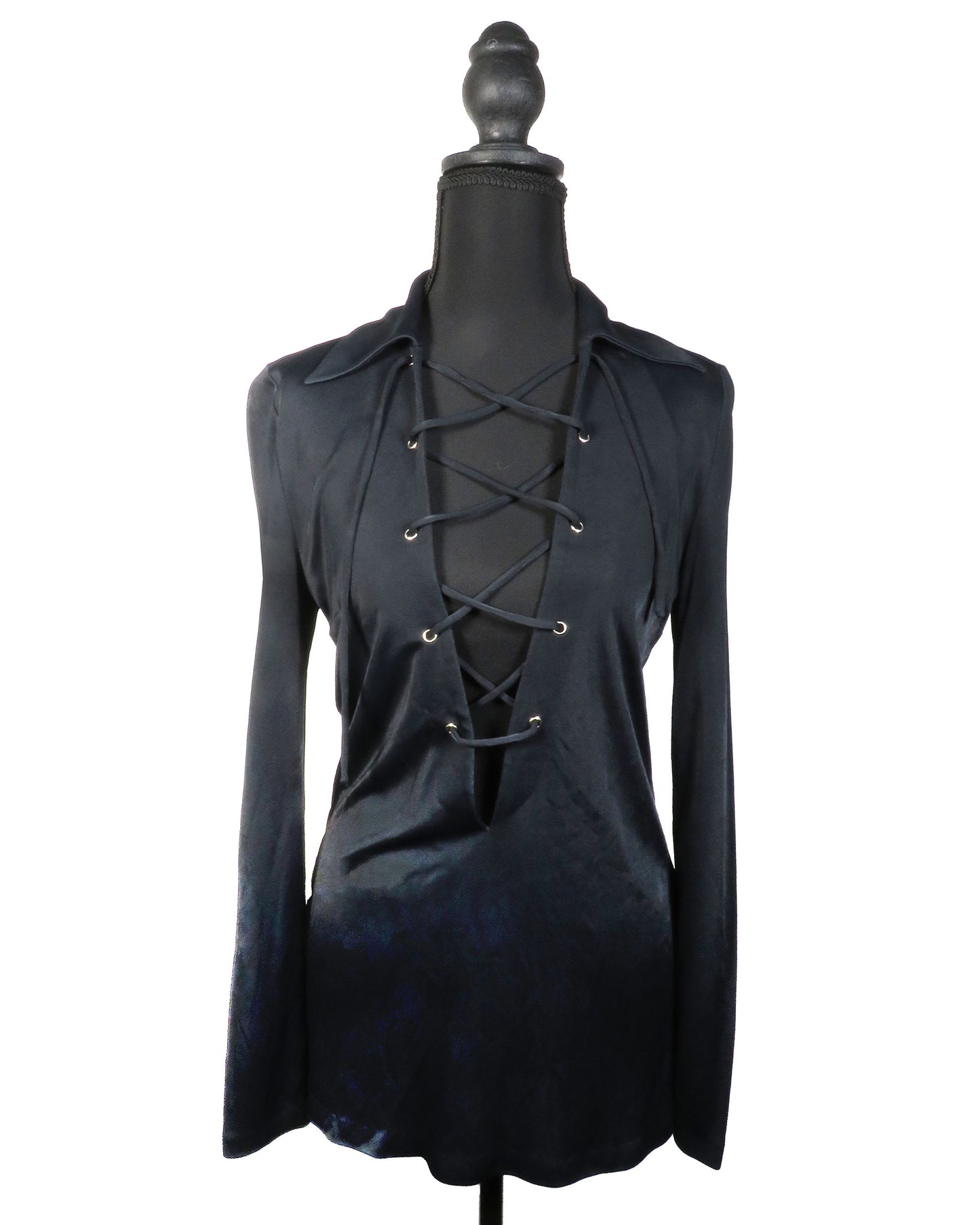 Black long-sleeve top with lace-up front on a mannequin against a white background