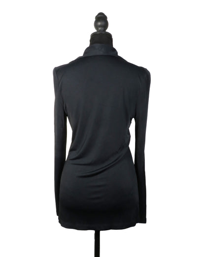 Black long-sleeve top on a mannequin against a white background