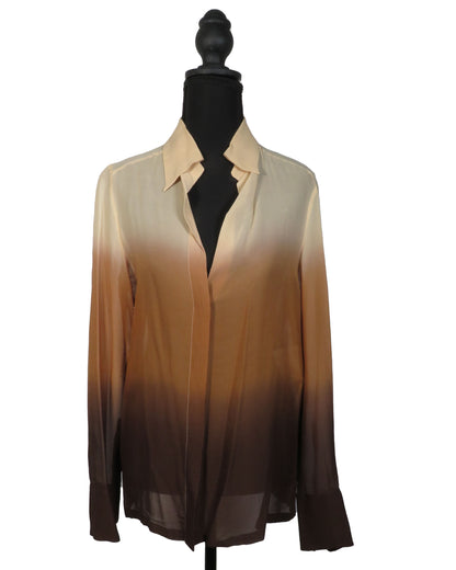 Sheer blouse with gradient color on a mannequin against a white background