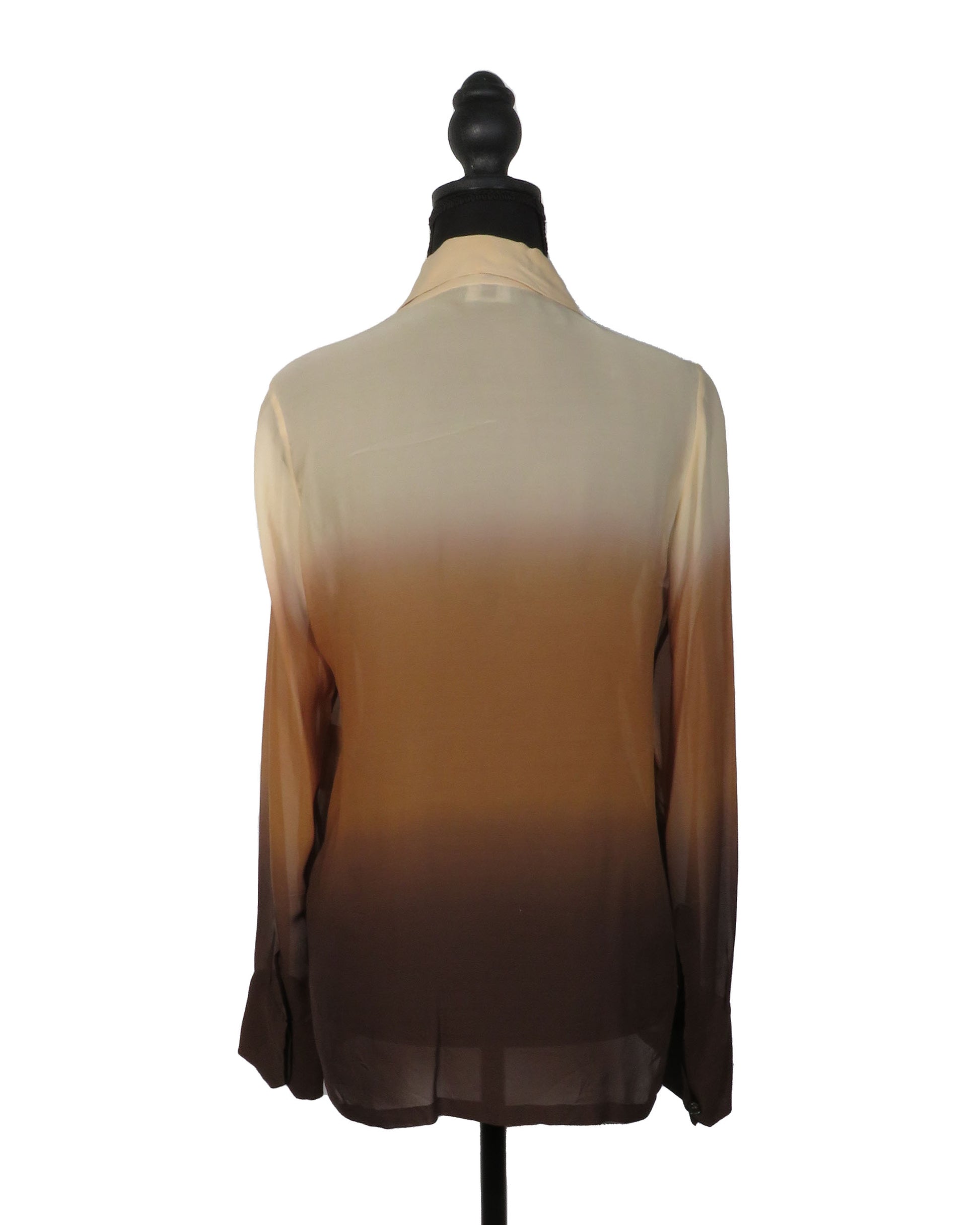 Sheer beige to brown gradient blouse on a mannequin against a white background