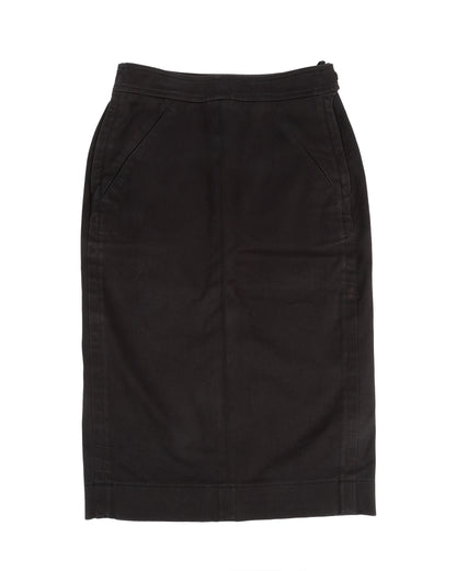 A black riding-inspired pencil skirt with front and back panels, side pockets, and adjustable buttoned tabs at the waistband.