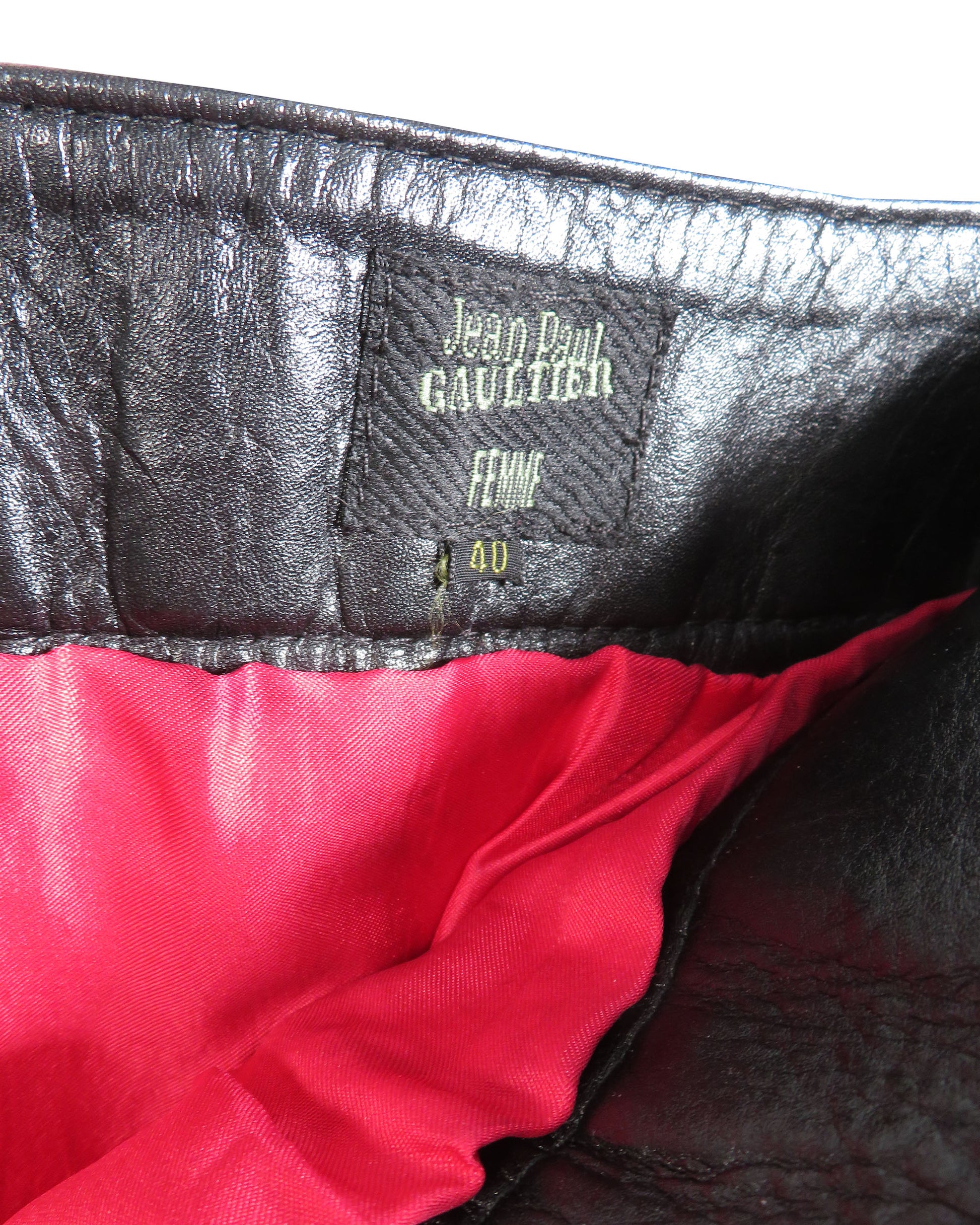 Close-up of a Jean Paul Gaultier label on a garment with red lining.
